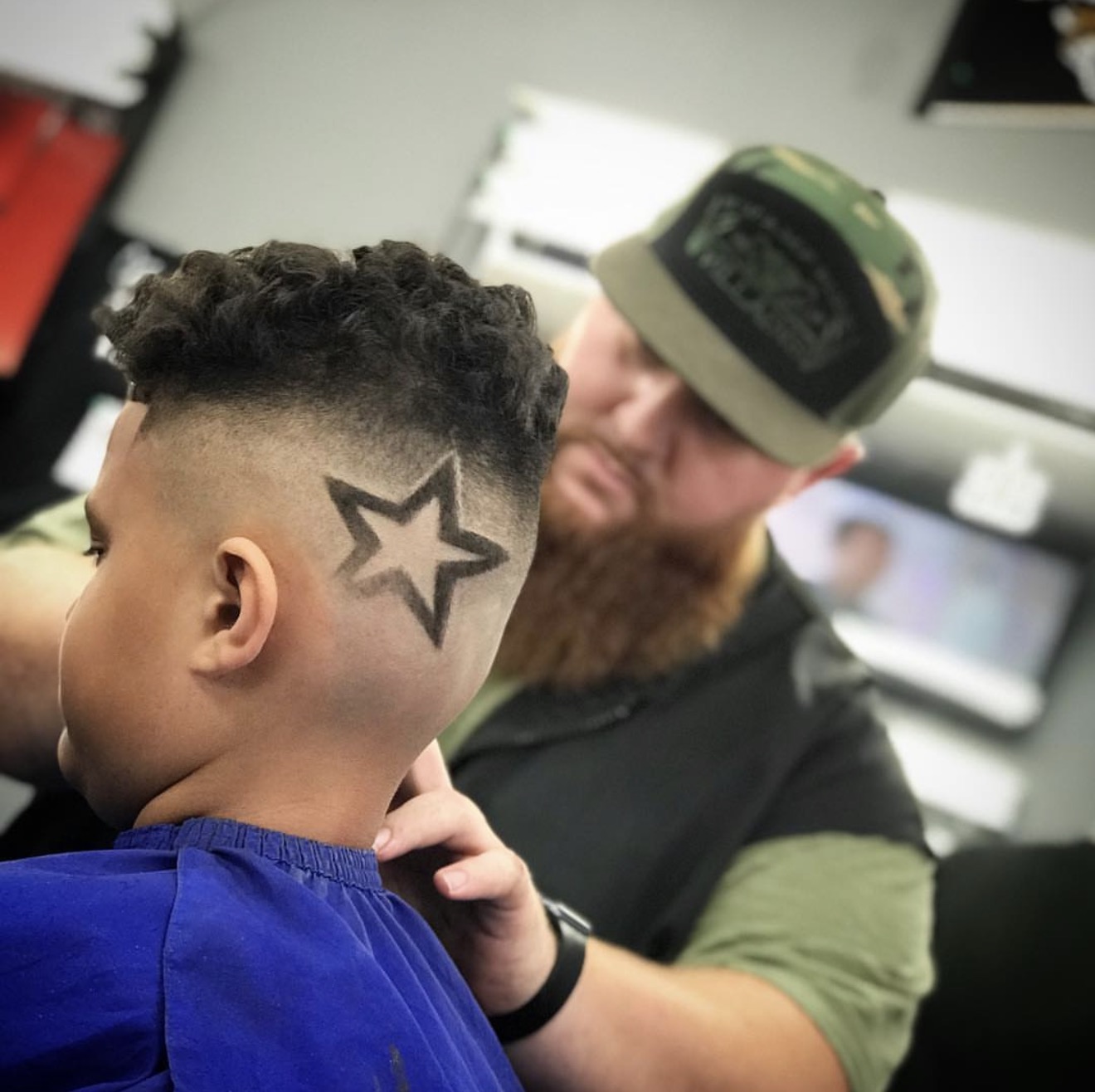 Bear Bryant, founder of ChairOS, cutting a client's hair